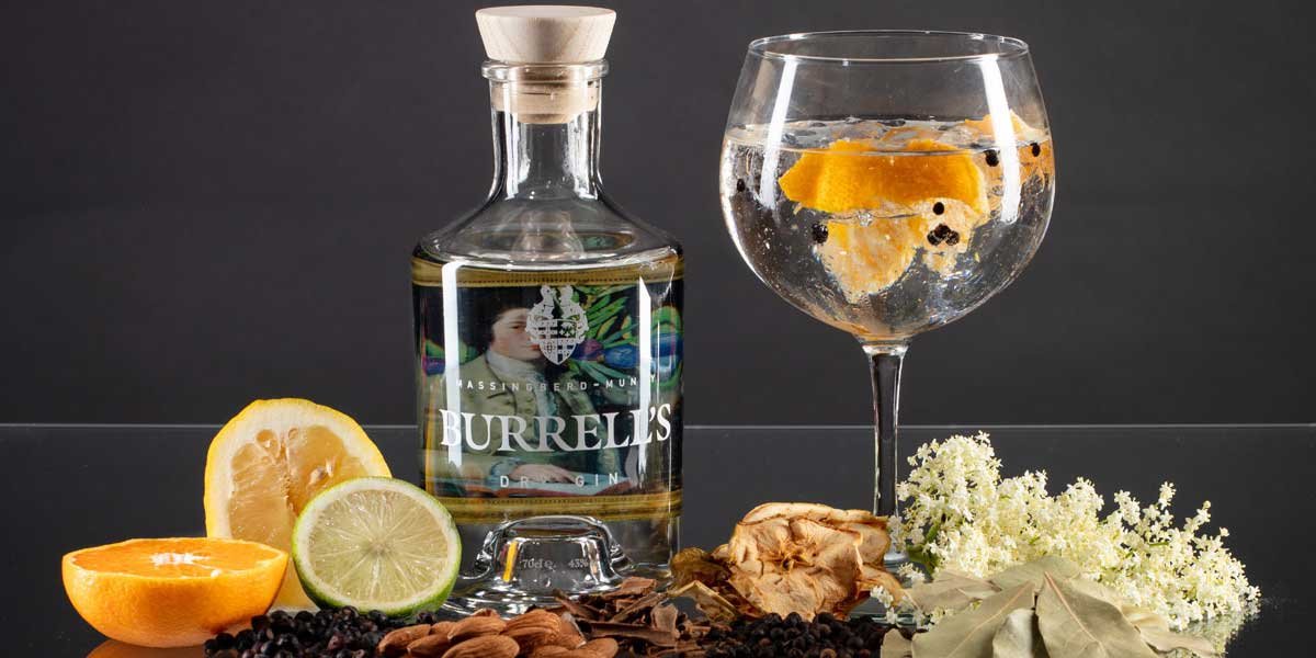 Burrells Dry Gin with a glass showing herbs and lemon